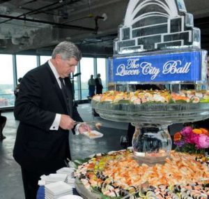 a man taking food from the ice fountain sculpture