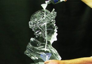 A drink poured onto an Ice Sculpture of a man