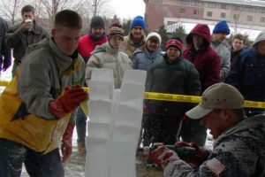 people looking at the ice Sculpture being carved