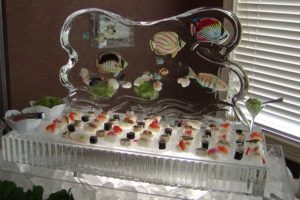 a beautiful ice Sculpture with food items on it