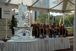 a group of women standing near an ice Sculpture