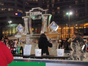 a woman near a Fountain Square Ice Sculpture