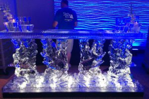 a man standing near a bar counter ice Sculpture