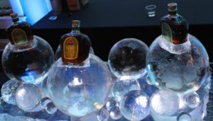 three bottles of drink placed on the ice balls