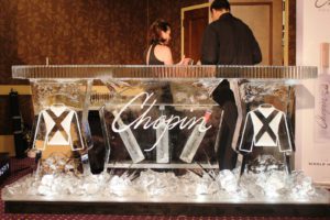 a men and woman standing near an ice bar counter