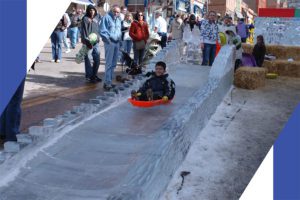 a little boy enjoying on an ice slide