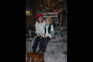 two little girls sitting on an Ice Sculpture chair