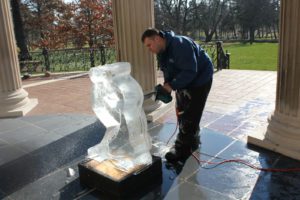 a man working on the lower part of an Ice Sculpture