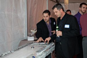 two men looking at an ice Sculpture